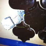 beveled arabesque tile marked for bottom of outlet cut